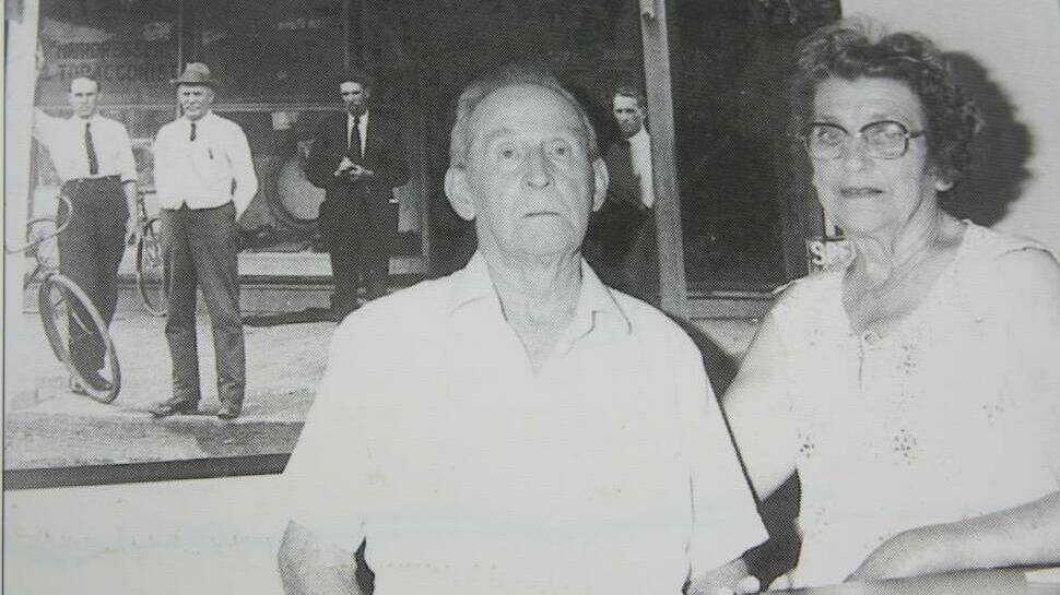 Cecil and Effie Brown at the Examiner office in 1982. Behind them is a picture of William Brown with Cecil (far right) and Raymond Terrace businessmen outside the Examiner's King Street office in the early 1900s.
