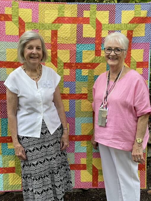 Nolda Mundey and Jean Margaret Chapple with of the quilts which are being raffled. Picture supplied.
