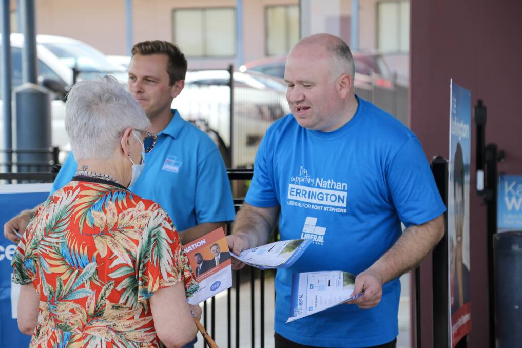 Nathan Errington greeting voters are Raymond Terrace pre-poll about lunchtime on Thursday, March 23. Picture by Ellie-Marie Watts