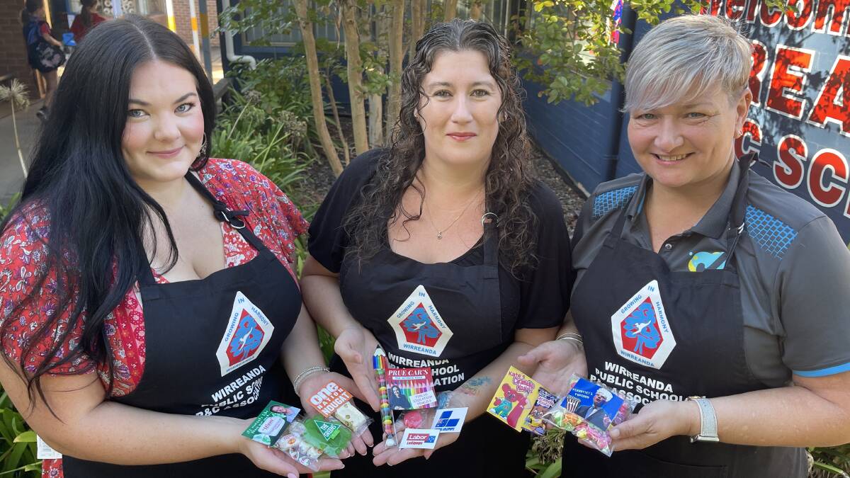 Wirreanda Public School P&C members Marina Warner, Rhiannon McCartney and Sal Rolfe with some of their punny election day lollies, which will be available to buy from the Medowie school on election day. 