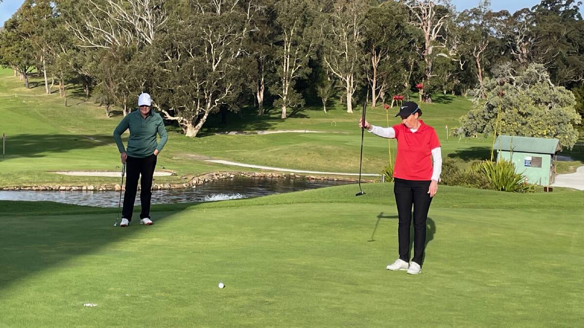 Gemma Dooley lining up her eagle winning putt with Katrina Skinner-Oyston looking on during the final round of the 2022 Nelson Bay Ladies Golf Classic. 