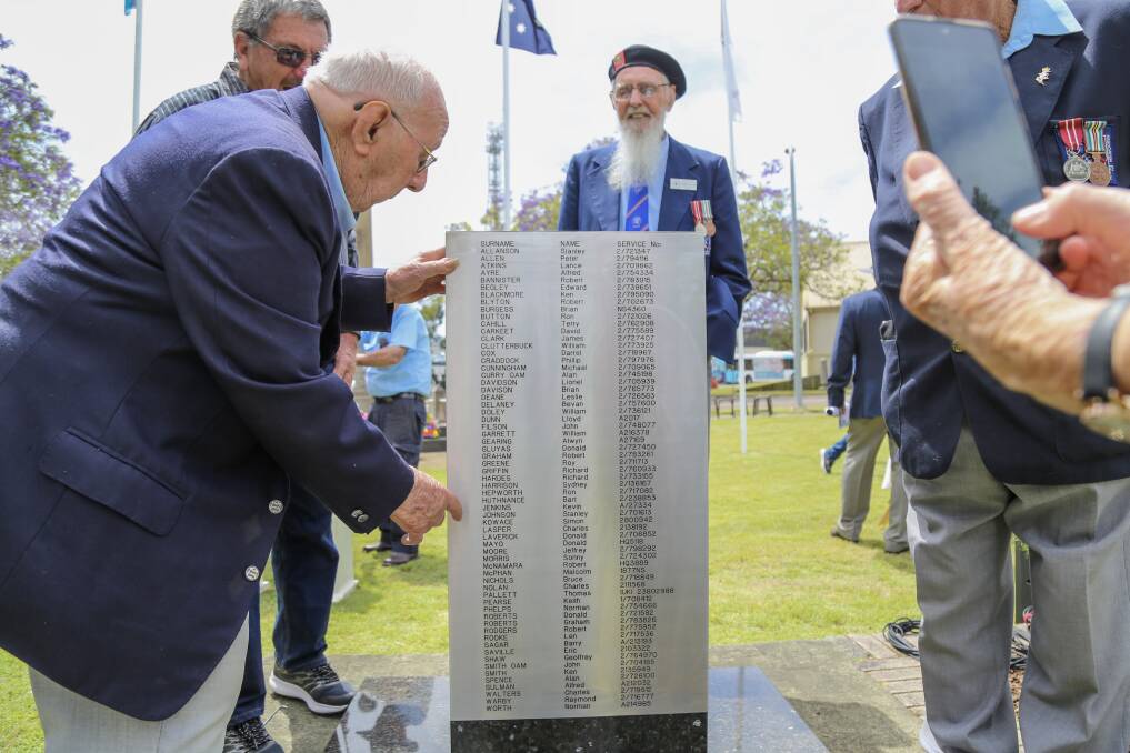 Kevin Jenkins pointing out his name on the newly plaque on the national servicemen's memorial in Anzac Park, Raymond Terrace.