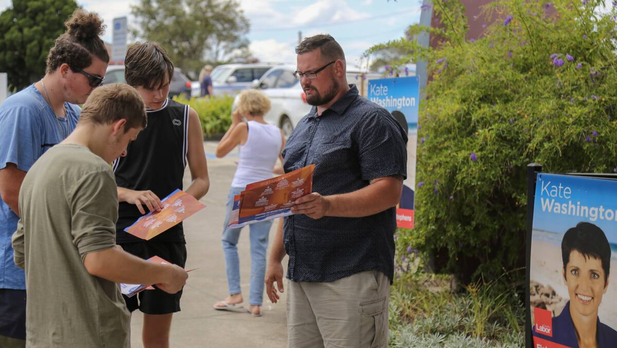 Port Stephens One Nation candidate Mark Watson speaking with young voters at the Raymond Terrace pre-poll on Thursday, March 23.