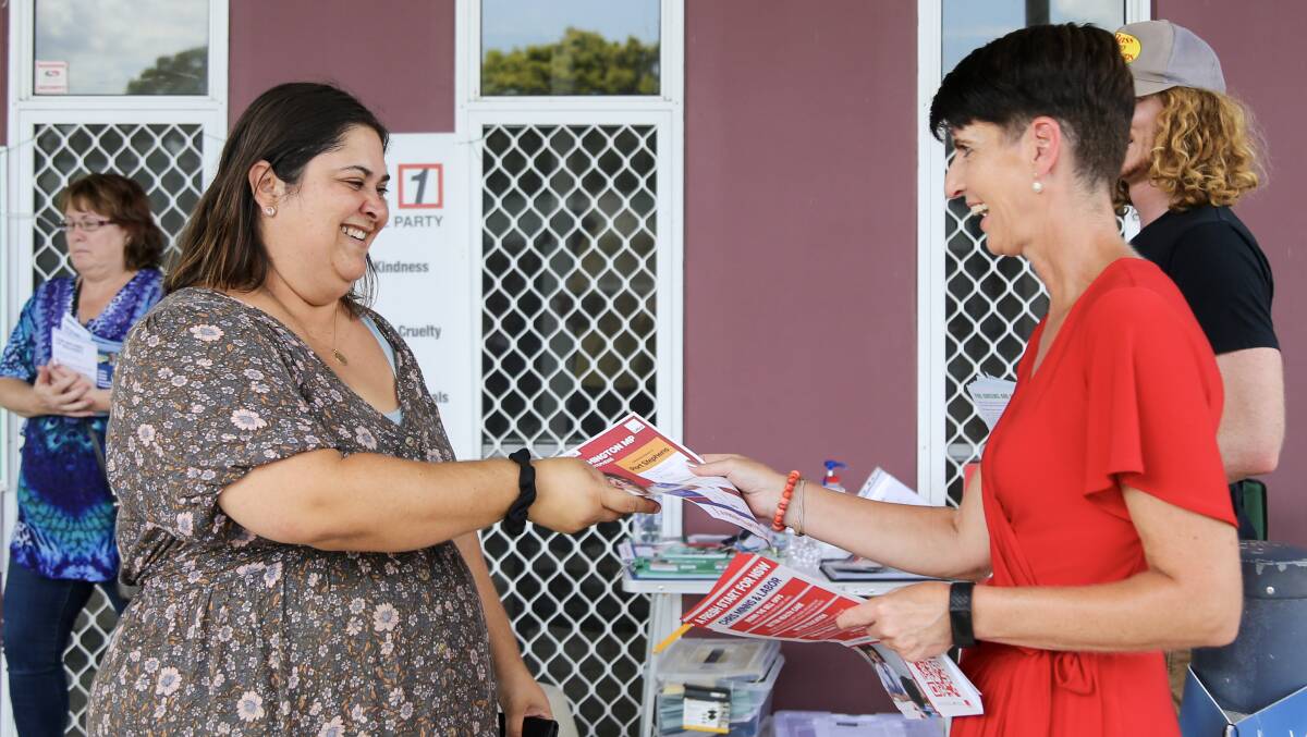 Karuah voter Michelle King receives a how to vote flier from Labor MP Kate Washington in Raymond Terrace on Thursday, March 23.