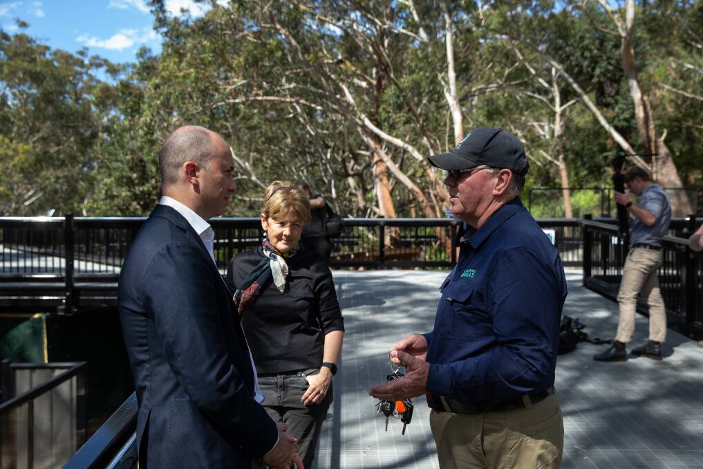 Port Stephens Koalas' Ron Land, right, talks with NSW Environment Minister Matt Kean and Parliamentary Secretary for the Hunter Catherine Cusack at the sanctuary's official opening. Picture: Marina Neil